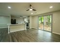 Bright living room featuring a sliding door that opens to the backyard and an open kitchen at 1995 Northerly Way, Stone Mountain, GA 30088