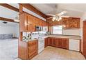 Functional kitchen featuring wood cabinets, white appliances, and tile countertops at 2762 Zingara Ne Rd, Conyers, GA 30012