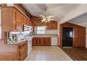 Well-lit kitchen features wood cabinets, white appliances, and tile flooring at 2762 Zingara Ne Rd, Conyers, GA 30012