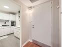 Home entryway with a view of the kitchen featuring white cabinets and modern appliances at 2965 Pharr Court South Nw # 110, Atlanta, GA 30305