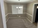 Cozy dining room features a window for natural light, neutral walls and carpeting at 4502 Cherie Glen Trl, Stone Mountain, GA 30083