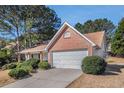 Charming home with a two-car garage, brick accents, and well-maintained landscaping at 11941 Fairway Overlook, Fayetteville, GA 30215