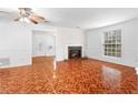 Spacious living room featuring a classic brick fireplace, ample natural light, and unique flooring at 3177 Shadow Walk Ln, Tucker, GA 30084