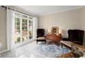 Cozy living room featuring elegant chairs, marble floors, a table, and a bright window showcasing natural light at 403 Mill Xing, Canton, GA 30114