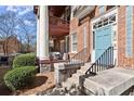 Inviting condo entrance with a blue door, brick facade and updated stairs at 746 N Highland Ne Ave # 11, Atlanta, GA 30306