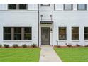 Inviting front entrance with a view of modern gray-and-white facade and minimalist landscaping at 1324 Parc Bench Rd, Atlanta, GA 30316