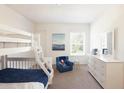 Bright bedroom featuring a bunk bed, blue chair, and dresser at 147 Silverton Dr, Dacula, GA 30019