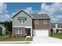 Attractive two-story home featuring a brick facade, two-car garage, and well-manicured lawn at 147 Silverton Dr, Dacula, GA 30019