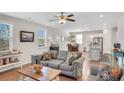 Bright and airy living room with hardwood floors, comfortable seating, and an open floor plan leading to the kitchen at 5345 Coltman Dr, Cumming, GA 30028