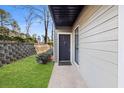 Inviting front entrance with gray siding, a dark door, and well-maintained landscaping at 601 Park Ridge Cir, Marietta, GA 30068