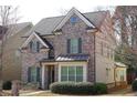 Beautiful two-story home with gray brick, trimmed windows and manicured landscaping at 3534 S Sherwood Se Rd, Smyrna, GA 30082
