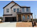 New construction home with a covered porch, two car garage, and brick and siding exterior at 7685 Homer Dr, Cumming, GA 30028