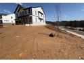 A view of the side of the house that shows the home sitting on a dirt lot at 7685 Homer Dr, Cumming, GA 30028
