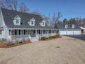 Charming home with a full front porch plus a detached garage with extra storage space at 3179 Meadow Trl, Loganville, GA 30052