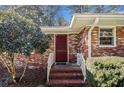 Close-up of the brick home's red front door and entrance at 2436 Hazelwood Ne Dr, Atlanta, GA 30345