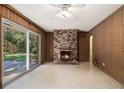 Cozy living room with a brick fireplace and sliding glass doors to the backyard at 2436 Hazelwood Ne Dr, Atlanta, GA 30345