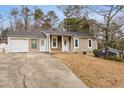 Charming single-story home with stone accents, covered entry, attached garage, and a well-maintained front yard at 4053 Overland Trl, Snellville, GA 30039