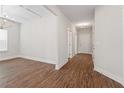 Bright hallway with wood flooring, fresh paint, and access to multiple rooms at 11204 Cornerstone Way, Hampton, GA 30228