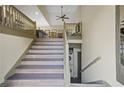 Stylish staircase leading to the upper level, showcasing modern design and architectural details at 136 Huntcliff Trl, Ellenwood, GA 30294