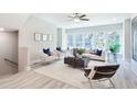 Bright living room featuring large windows, ceiling fan, and stylish furniture at 3808 Jack Vernon Cir, Powder Springs, GA 30127
