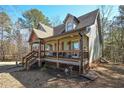 Side view of a craftsman-style home with a welcoming front porch and manicured landscaping at 9001 East Carroll Rd, Winston, GA 30187