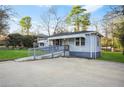 Well-maintained single story home with ramp, large driveway, and partially fenced yard at 391 Mount Zion Sw Rd, Atlanta, GA 30354