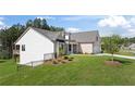 Lovely home featuring a manicured lawn, a two-car garage and elegant brick accents at 477 Northside Dr, Canton, GA 30115