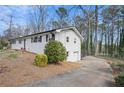 Side view of a charming home featuring a convenient driveway and a well-manicured yard at 1740 Starlight Dr, Marietta, GA 30062