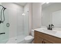 Modern bathroom with a glass-enclosed shower, sleek vanity, and neutral finishes at 7525 Homer Dr, Cumming, GA 30028