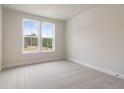 Clean and bright bedroom with gray carpet, fresh paint, and plenty of natural light at 7525 Homer Dr, Cumming, GA 30028