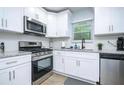 Bright kitchen featuring stainless steel appliances, granite countertops, and ample cabinet space at 2410 Macon Sw Dr, Atlanta, GA 30315