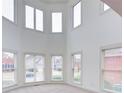Bright bonus room with high ceilings, carpet, and multiple windows offering natural light at 5004 Duxford Se Dr, Smyrna, GA 30082