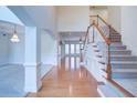 Grand foyer with high ceilings, hardwood floors, staircase, and elegant chandelier at 5004 Duxford Se Dr, Smyrna, GA 30082