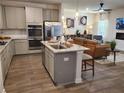 Modern kitchen features a granite island, stainless appliances and an open living space at 5372 Tolar Rd, South Fulton, GA 30213