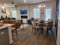 Open concept living room featuring a modern fireplace, dining area and comfortable seating at 5372 Tolar Rd, South Fulton, GA 30213