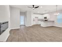 Open-concept living room with a fireplace, modern lighting, and a view of the adjacent kitchen at 5372 Tolar Rd, South Fulton, GA 30213