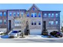 Charming brick townhomes feature attached garages and a traditional architectural style at 373 Via Secco Ln, Suwanee, GA 30024