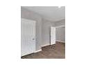 This bedroom features neutral paint, updated carpet, and closet storage at 5324 Tolar Rd, South Fulton, GA 30213