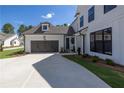 Beautiful home with a dark gray two car garage and a well maintained front yard at 574 Sawnee Village Blvd, Cumming, GA 30040