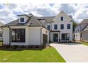 A gorgeous two-story home features a two-car garage and a meticulously kept front yard at 574 Sawnee Village Blvd, Cumming, GA 30040
