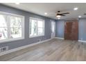 Bright living room with a ceiling fan, two large windows, and light-colored wood floors at 1546 Alverado Way, Decatur, GA 30032