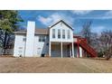 Spacious backyard view showcasing a deck with stairs, a chimney, and a partially fenced yard at 3336 Franklin Forest Dr, Winston, GA 30187
