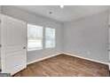 Bright bedroom with hardwood floors, a large window, and a closet at 5337 Tolar Rd, South Fulton, GA 30213