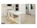 Modern kitchen with a white island, stainless steel appliances, and a breakfast bar at 5337 Tolar Rd, South Fulton, GA 30213