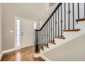 A bright entry foyer features hardwood floors and an elegant staircase at 5430 Falls Landing Dr, Cumming, GA 30040