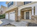 Inviting front porch with stone accents and a two-car garage at 5430 Falls Landing Dr, Cumming, GA 30040