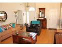 Open-concept living area with hardwood floors, comfortable seating, and natural light at 1358 Apple Orchard Ln, Snellville, GA 30078