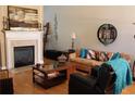 Inviting living room featuring a cozy fireplace, hardwood floors, and stylish decor at 1358 Apple Orchard Ln, Snellville, GA 30078