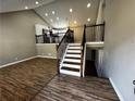 Spacious living room features hardwood floors and staircase with iron railings and a cathedral ceiling at 3817 Raiders Ridge Dr, Lithonia, GA 30038