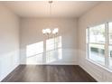 Bright dining room with natural light, chair railing, and hardwood floors at 4853 Walkers Green, Mableton, GA 30126